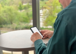 Businessman using mobile device with blank screen mockup friendly
