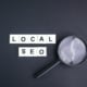 magnifying glass with local seo alphabet words.