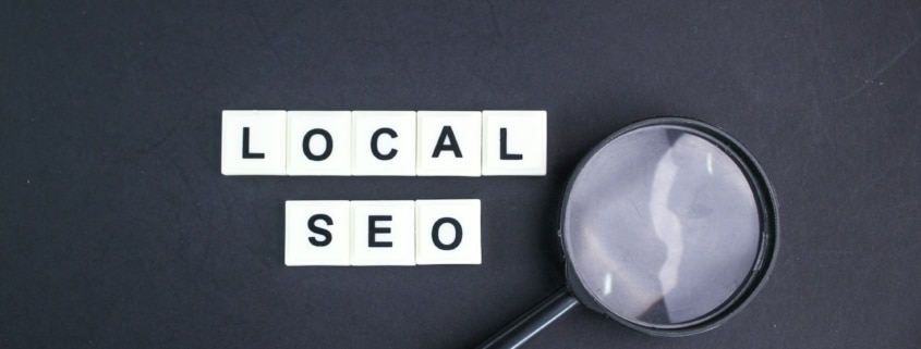 magnifying glass with local seo alphabet words.