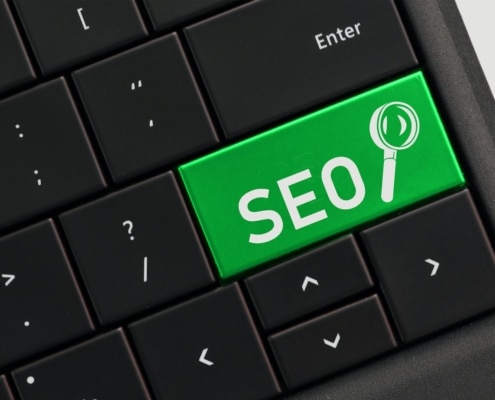Search engine optimization concept - SEO with magnifying glass on computer key keyboard