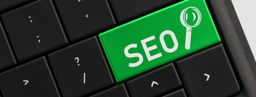 Search engine optimization concept - SEO with magnifying glass on computer key keyboard