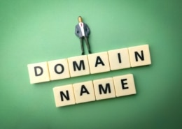 Miniature people and toys word with the word DOMAIN NAME